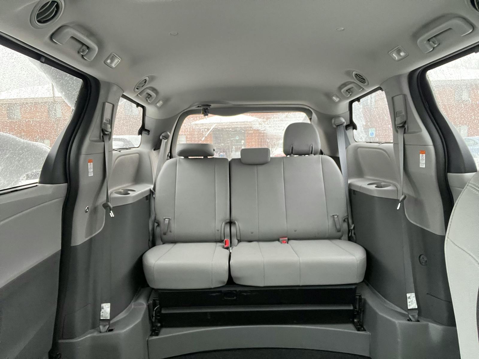The spacious interior of a wheelchair accessible maxi van with seating for carers and family.